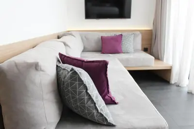a white couch with purple pillows in a living room at Athens Lodge by Athens Prime Hotels in Athens