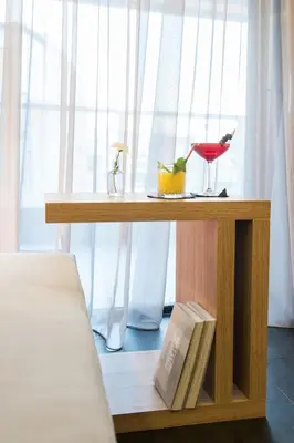a table with a book and a bird sitting on it at Athens Lodge by Athens Prime Hotels in Athens