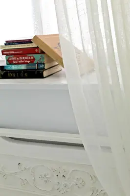 a stack of books sitting on a shelf next to a window at By the Acropolis, In the heart of Plaka! in Athens