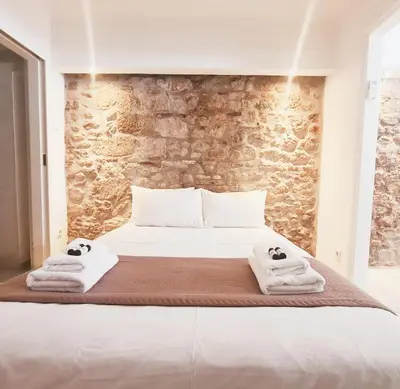 a bedroom with a bed with towels on it at Back to Tradition, by the Acropolis! in Athens