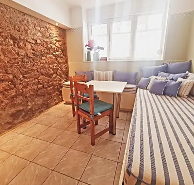 a living room with a table and a couch at Back to Tradition, by the Acropolis! in Athens