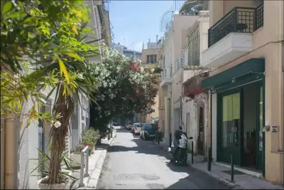 a street with buildings and a scooter parked on the sidewalk at Back to Tradition, by the Acropolis! in Athens