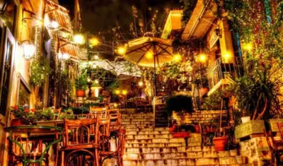 a set of stairs with tables and an umbrella at Back to Tradition, by the Acropolis! in Athens
