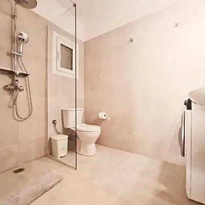 a bathroom with a toilet and a glass shower at Back to Tradition, by the Acropolis! in Athens
