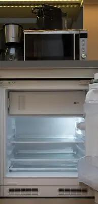 a refrigerator with its door open and a microwave at Skoufa Apartment in Athens