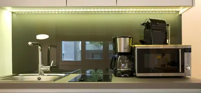 a kitchen counter with a microwave and a sink at Skoufa Apartment in Athens