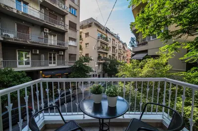 a balcony with a table with two plants on it at Skoufa Apartment in Athens