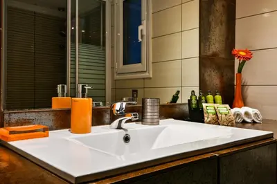 a white sink in a kitchen with a mirror at Star Parthenon Apartment in Athens