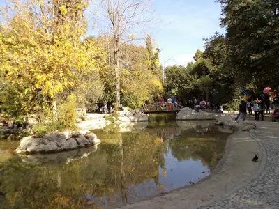 a bridge over a river in a park at Star Parthenon Apartment in Athens