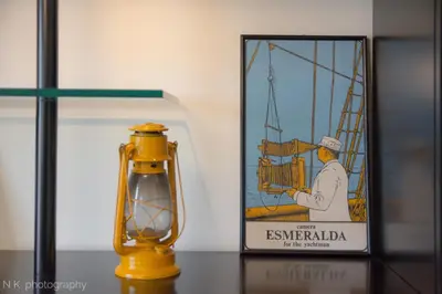 a yellow lamp on a table next to a picture at ATHENStay Penthouse Suite in Athens