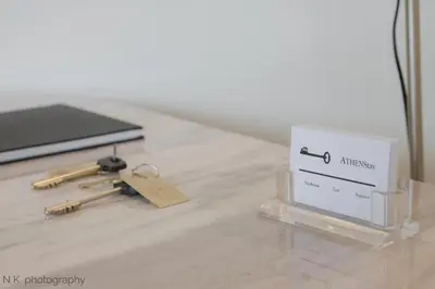 a box and keys on a table with a laptop at ATHENStay Penthouse Suite in Athens