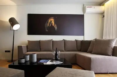 a living room with a couch and a table at Elliniko Luxury Residence by First Class Properties in Athens