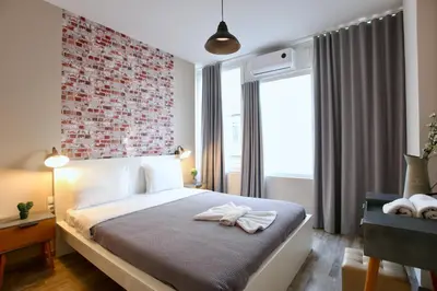 a bedroom with a bed with a red brick wall at GK Ermou Str in Athens