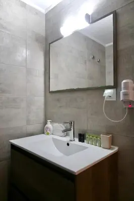 a bathroom with a white sink and a mirror at GK Ermou Str in Athens