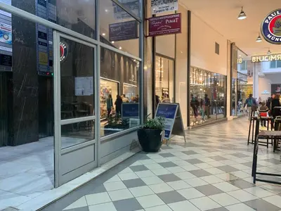 a shopping mall with people walking down a sidewalk at GK Ermou Str in Athens