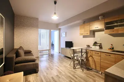 a kitchen and living room with a couch and a table at GK Ermou Str in Athens