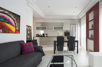 a living room with a couch and a table with chairs at Glyfada Riviera Home in Athens