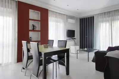 a living room with a dining room table and chairs at Glyfada Riviera Home in Athens