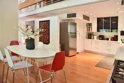 a kitchen and dining room with a white table and chairs at Villa Amaryllis in Athens