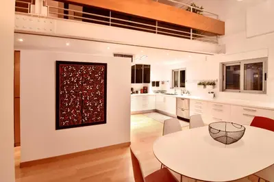 a kitchen with a white table and a dining room at Villa Amaryllis in Athens