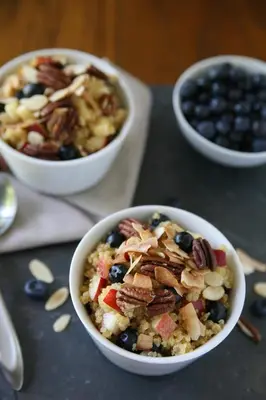 two bowls of food with nuts and blueberries on a table at Aerides 3 Luxury Suites in Athens