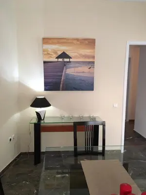 a desk in a room with a painting on the wall at Apartment in Markopoulo center in Markopoulo