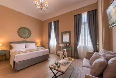 a hotel room with a bed and a couch at Palladian Home in Athens