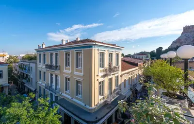a yellow building with white columns at Palladian Home in Athens