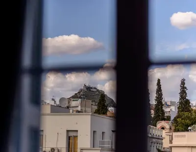 a view of a mountain through a window at Palladian Home in Athens