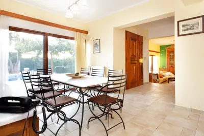 a kitchen and dining room with a table and chairs at Villa Soula in Anavissos