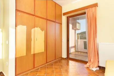 a living room with a large window and a room at Villa Soula in Anavissos