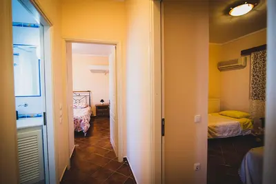 a hallway of a room with two beds and a window at Villa Soula in Anavissos