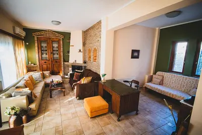 a living room with a couch and a table at Villa Soula in Anavissos