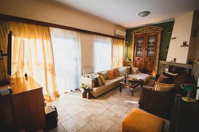 a living room with a couch and a table at Villa Soula in Anavissos