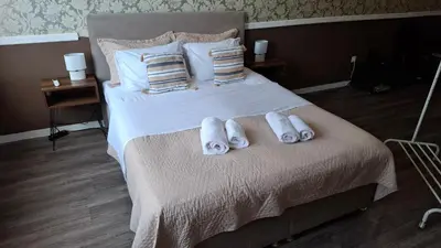 a bedroom with a bed with towels on it at Ermou & Athinas Suites in Monastiraki in Athens