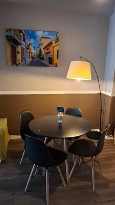 a table and chairs in a room with a painting on the wall at Ermou & Athinas Suites in Monastiraki in Athens