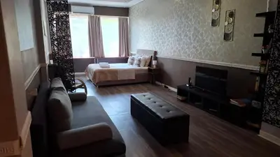 a living room with a couch and a bed at Ermou & Athinas Suites in Monastiraki in Athens