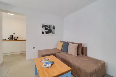 a living room with a brown couch and a table at Athens Residence Apartments in Athens