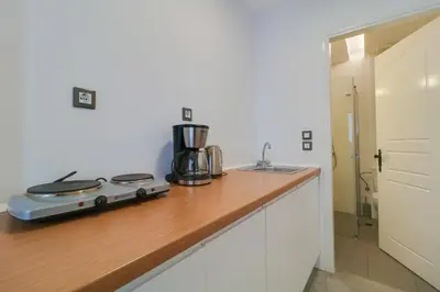 a kitchen counter with a stove and a sink at Athens Residence Apartments in Athens