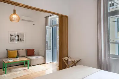 a bedroom with a bed and a couch and a table at Athens Residence Apartments in Athens