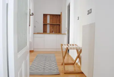 a hallway with a bench and a table in a room at Athens Residence Apartments in Athens