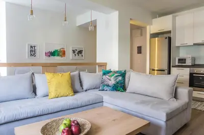 a living room with a couch and a table at The Athens Insider in Athens