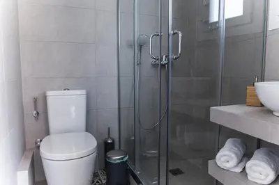 a bathroom with a shower with a toilet and a sink at The Athens Insider in Athens