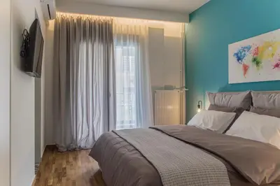 a bedroom with a large bed and a window at The Athens Insider in Athens