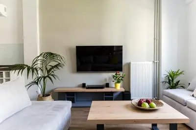 a living room with a couch and a table with a bowl of fruit at The Athens Insider in Athens