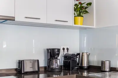 a kitchen counter with coffee makers on a counter top at The Athens Insider in Athens