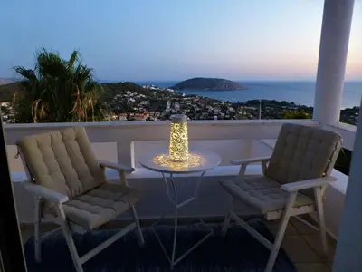 two chairs and a table on a balcony with a view at Seaview near Athens & Sounio in Anavissos