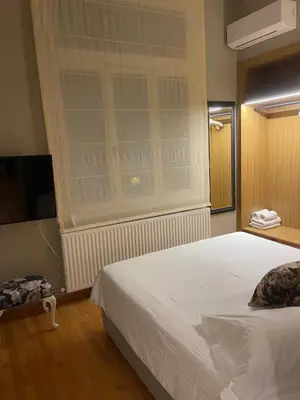 a bedroom with a white bed and a window at Athens-Plaka, Peter's House in Athens