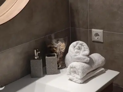 a bathroom with towels sitting on a counter at Athens-Plaka, Peter's House in Athens