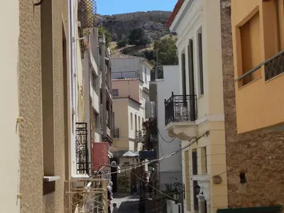 an alley with buildings and a hill in the background at Athens-Plaka, Peter's House in Athens